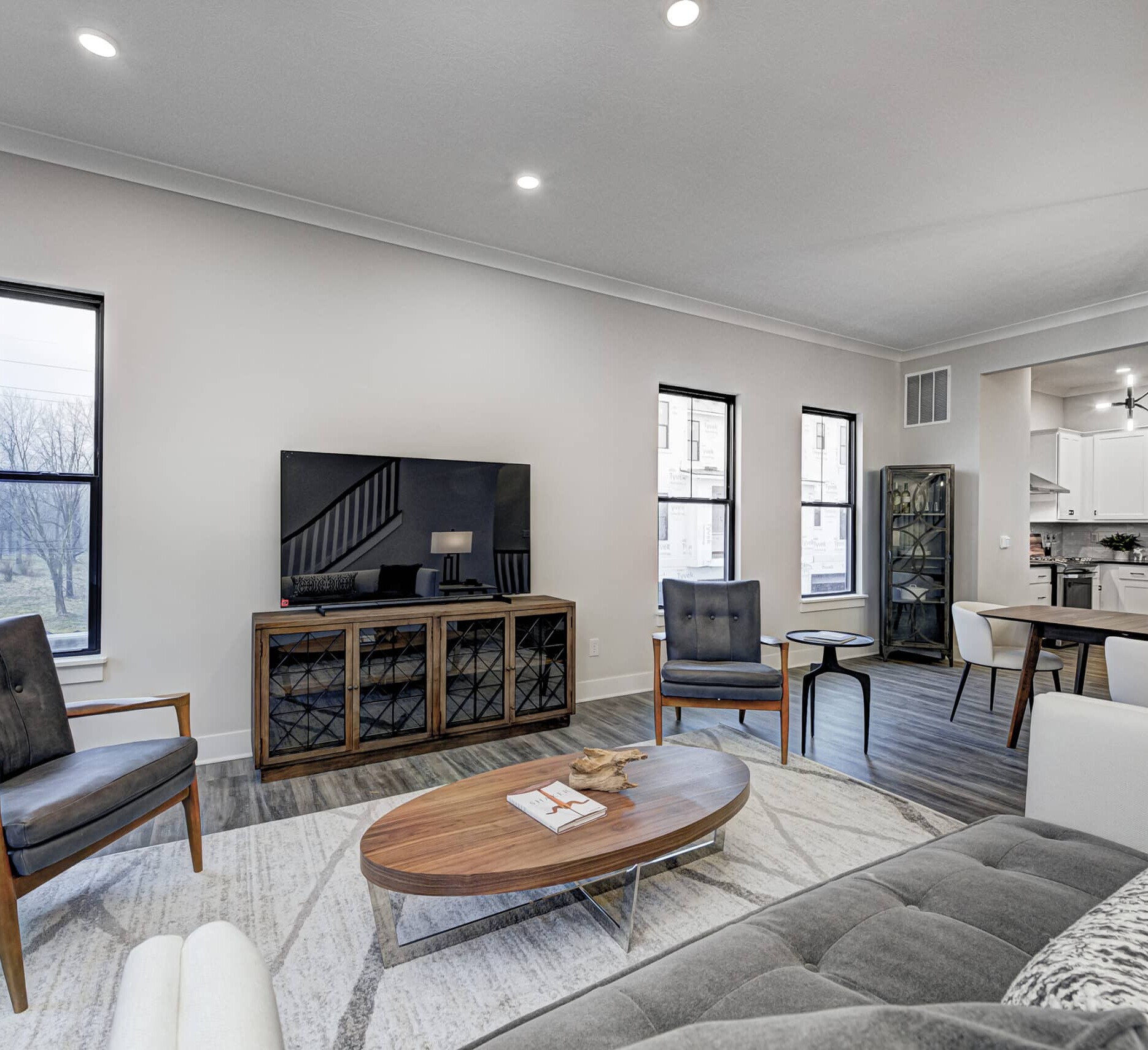A living room with couches and a TV, designed by a Custom Home Builder Carmel Indiana.