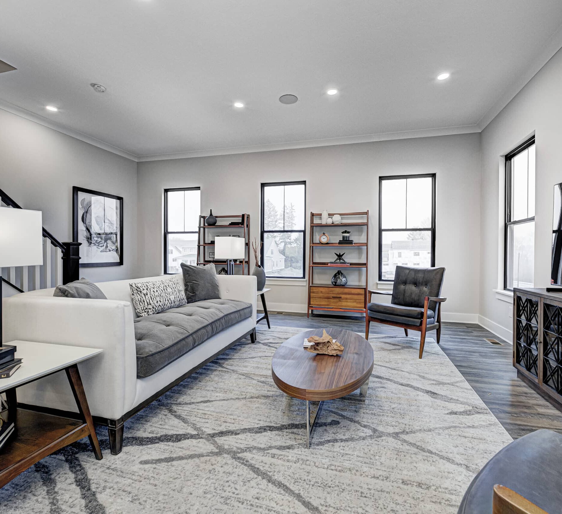 A custom home builder in Fishers, Indiana, created a stunning living room with comfortable couches and a high-end TV. The design of this new home in Carmel, Indiana highlights the perfect blend