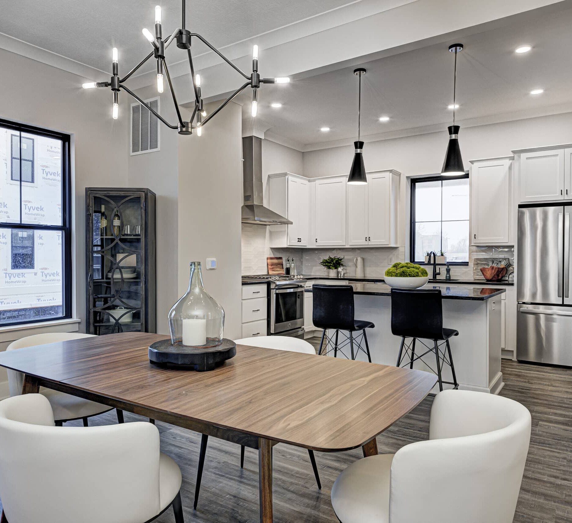 A contemporary kitchen with a dining table and chairs.