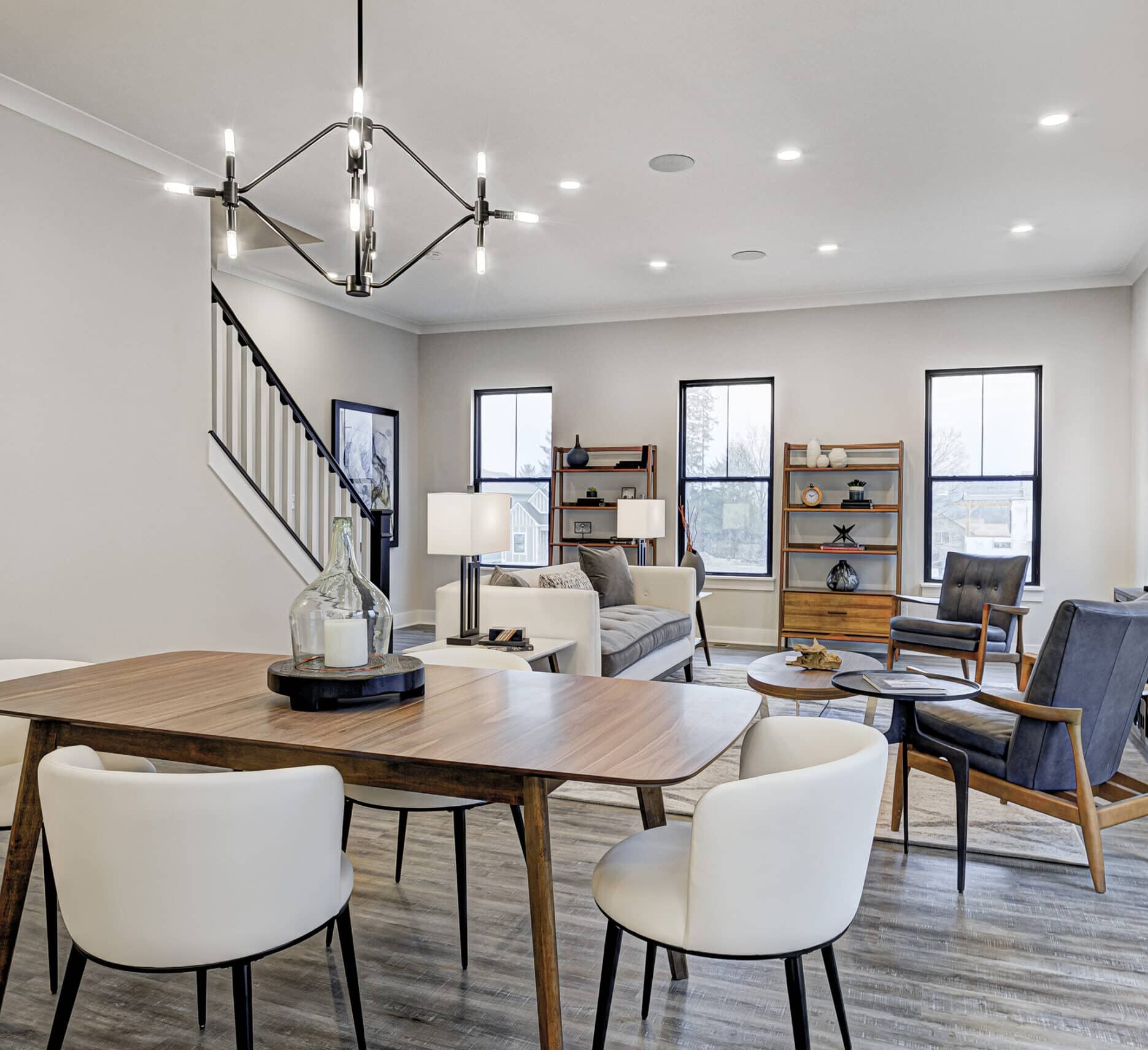 A living room with a dining table and chairs, perfect for custom home builders in Carmel Indiana or Fishers Indiana looking to create new homes.