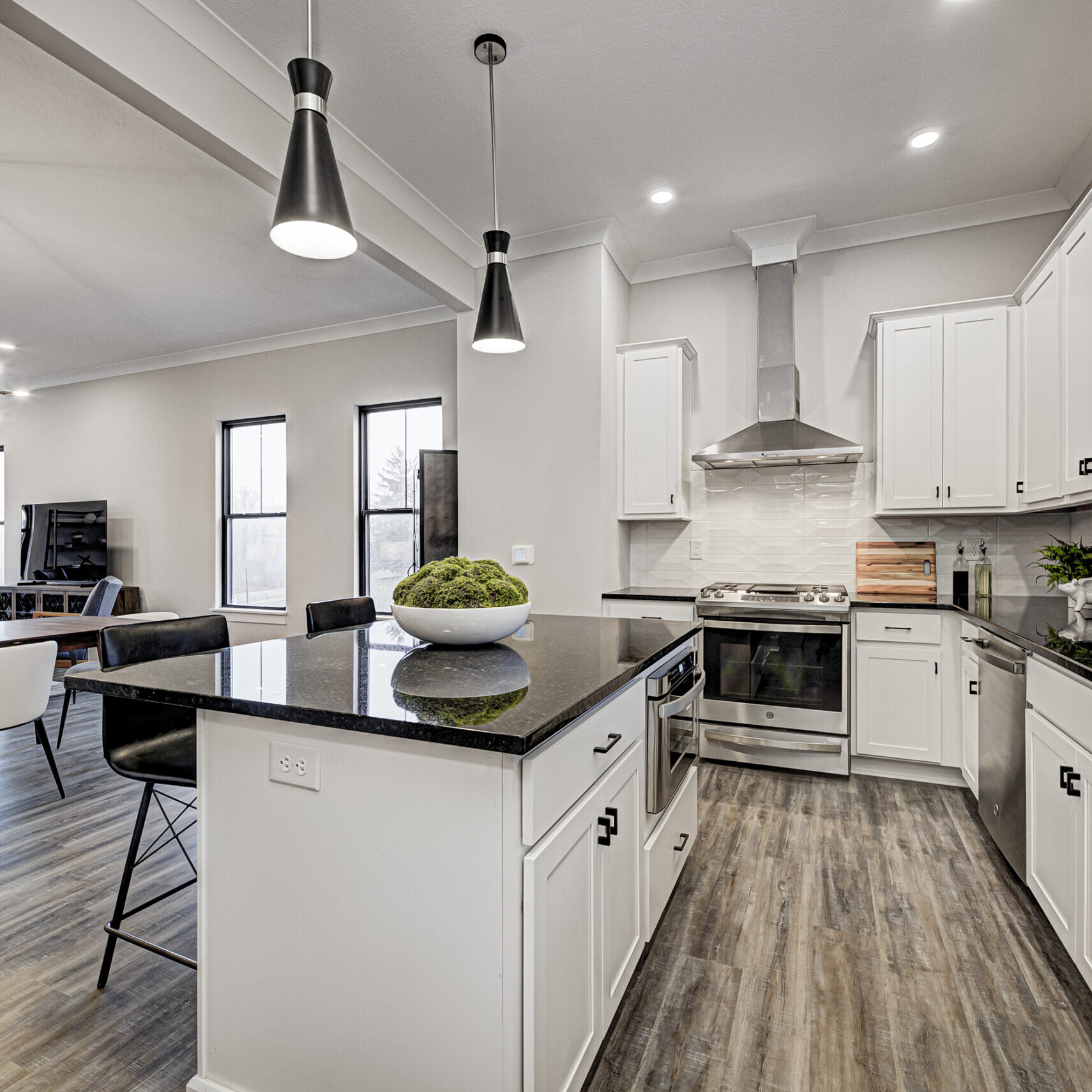 An Indianapolis Custom Home with white cabinets and black counter tops.