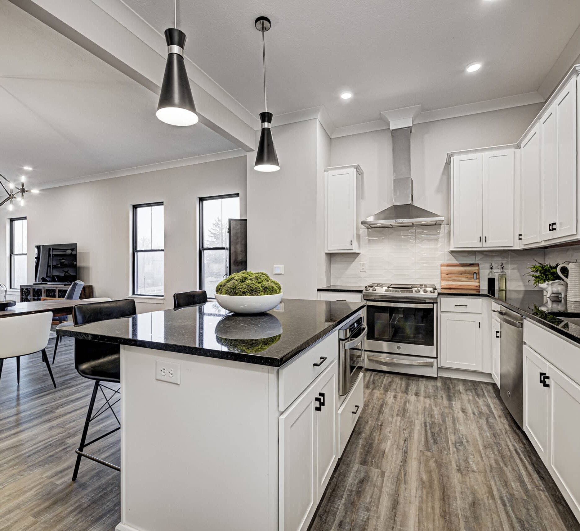 An Indianapolis Custom Home with white cabinets and black counter tops.