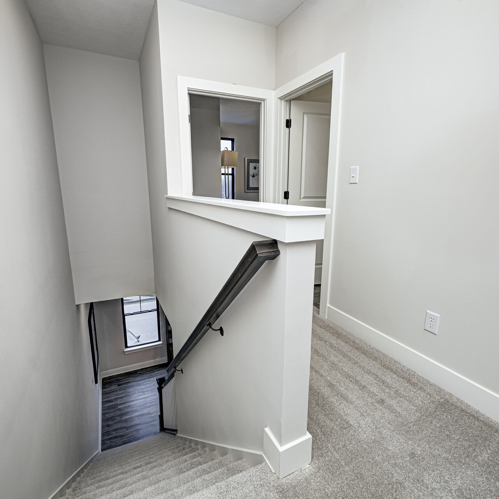 A custom-built stairway leading to a bedroom in a new home.