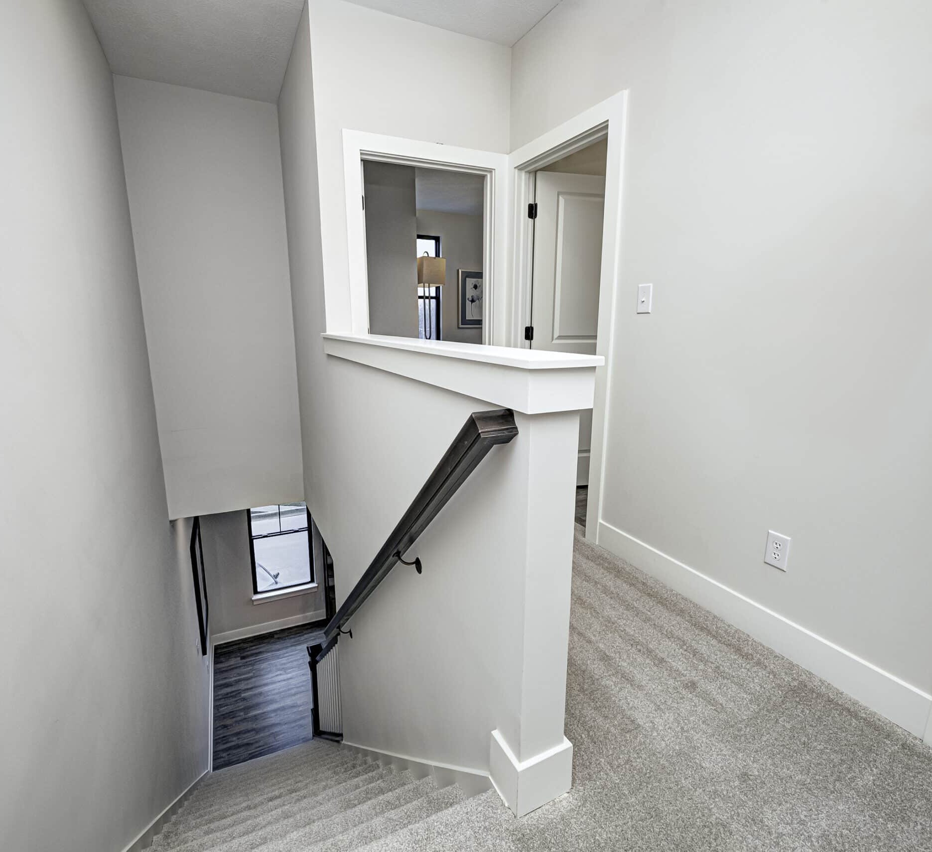 A custom-built stairway leading to a bedroom in a new home.