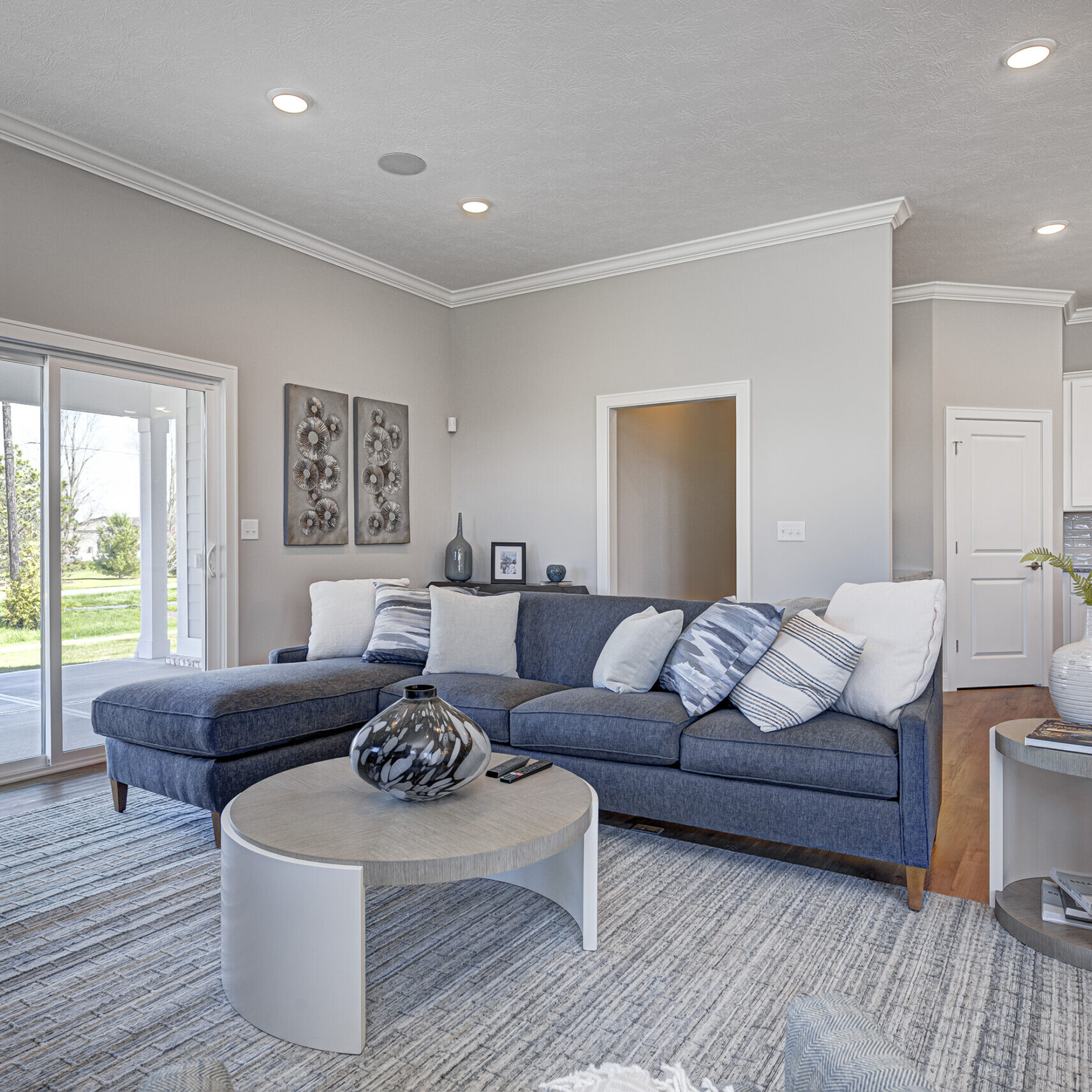 A living room with a gray couch and coffee table, designed by a Custom Home Builder in Carmel Indiana.