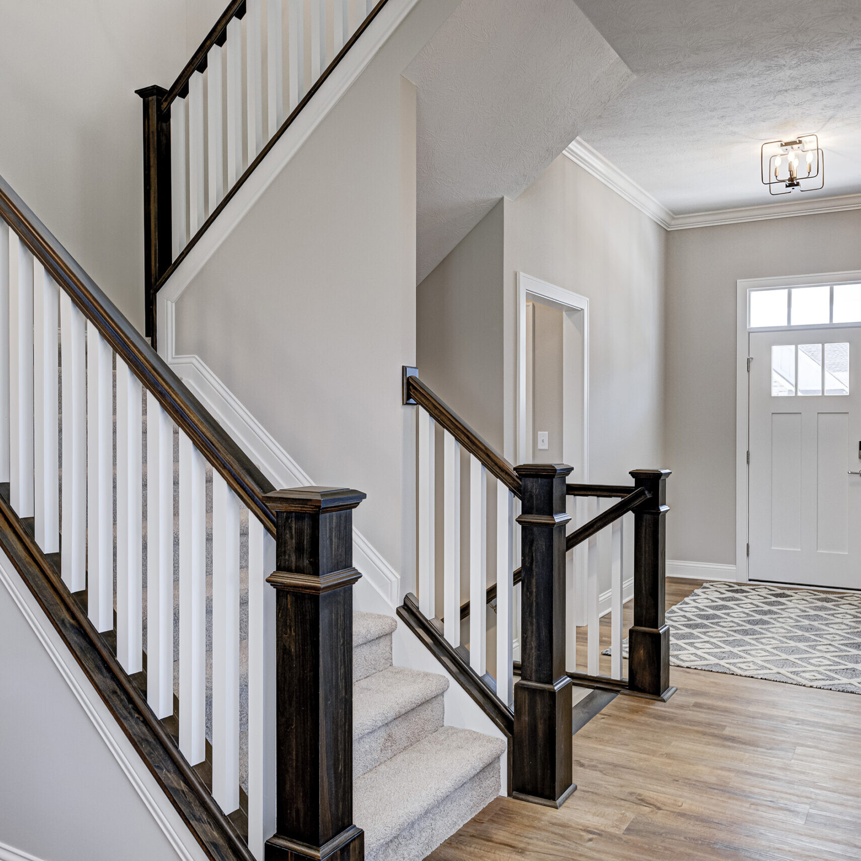 A custom home with a stairway and hardwood flooring in Fishers, Indiana.