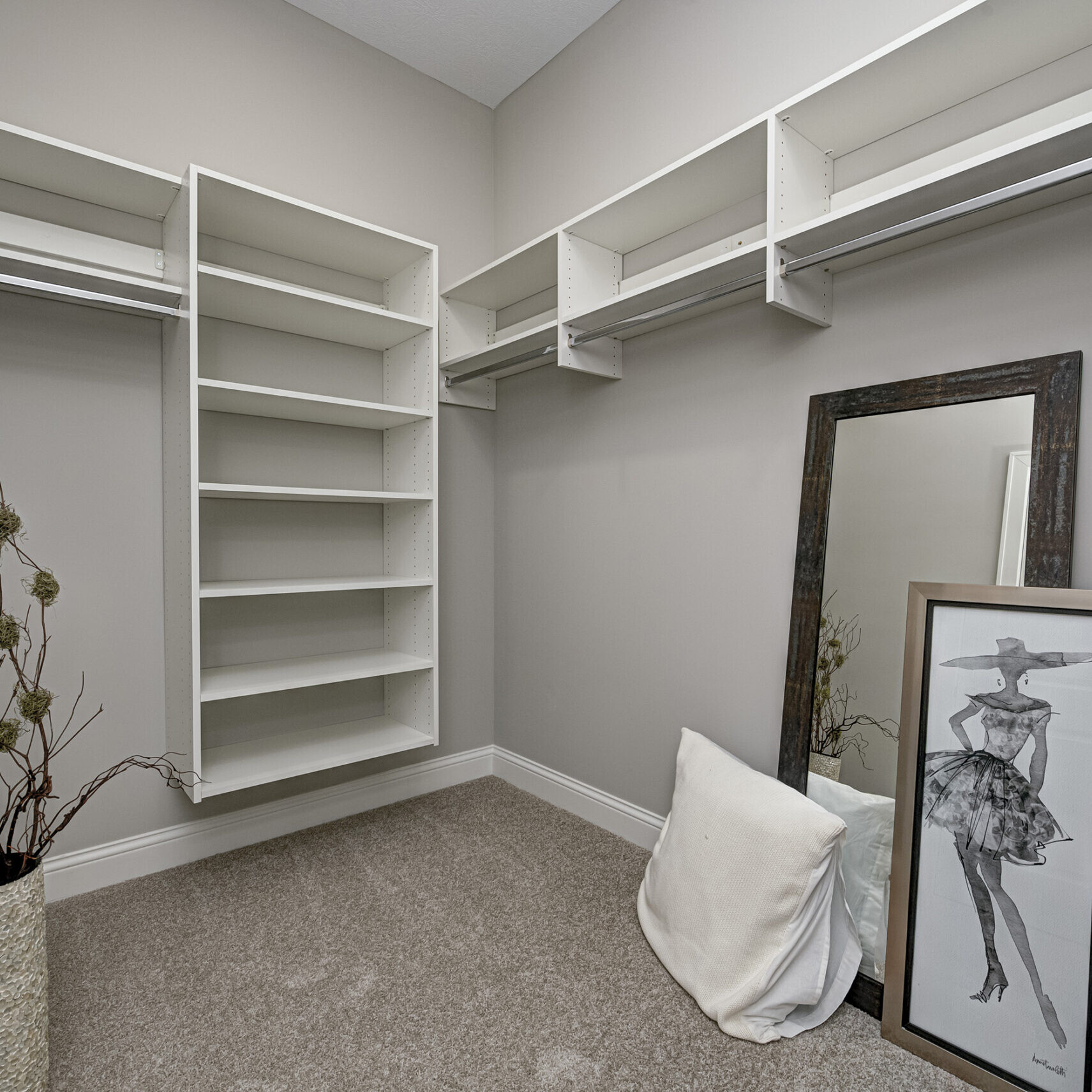 A custom walk-in closet in a Westfield, Indiana home, featuring shelves and a mirror.