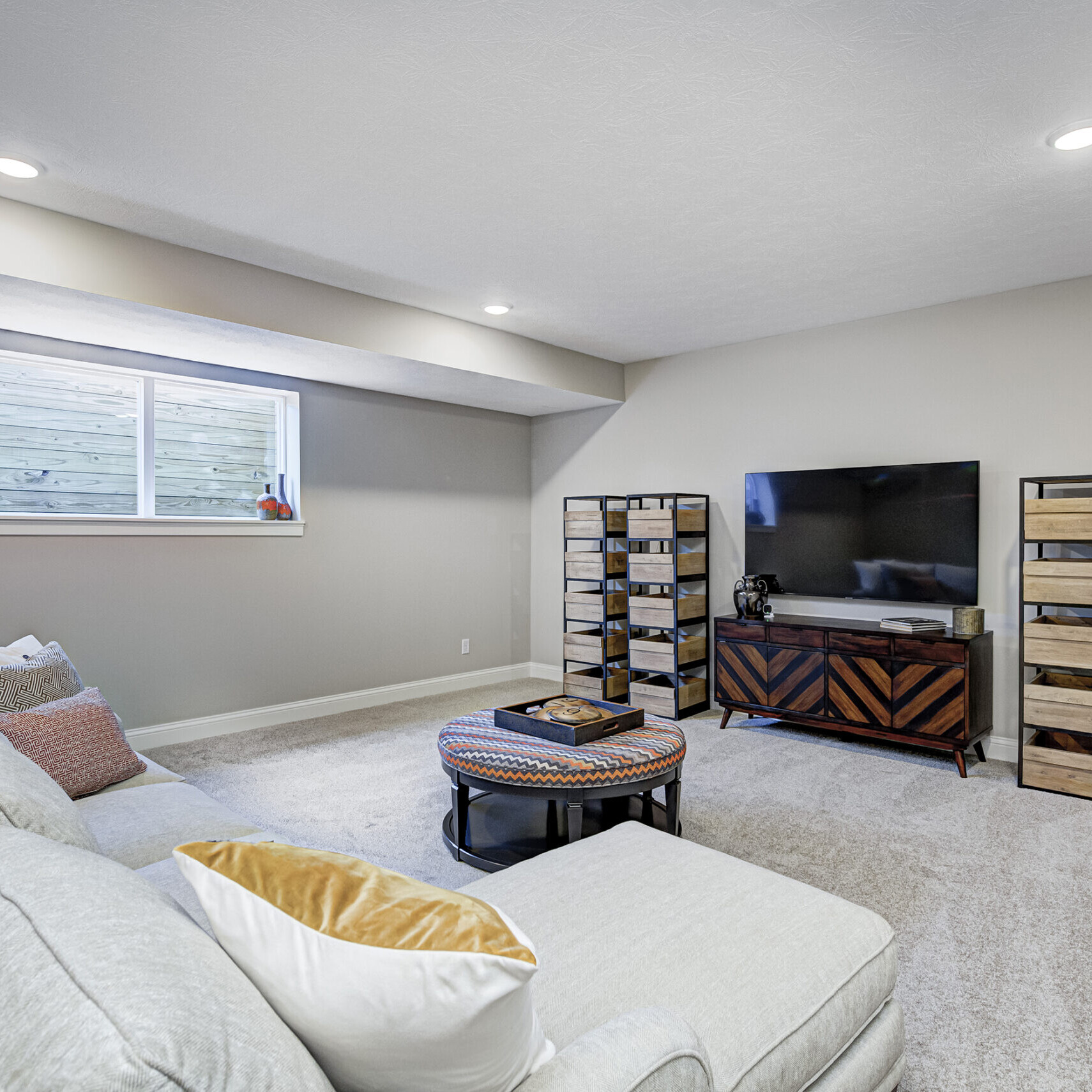 A living room with a couch and tv, designed by an Indianapolis Custom Homes builder.