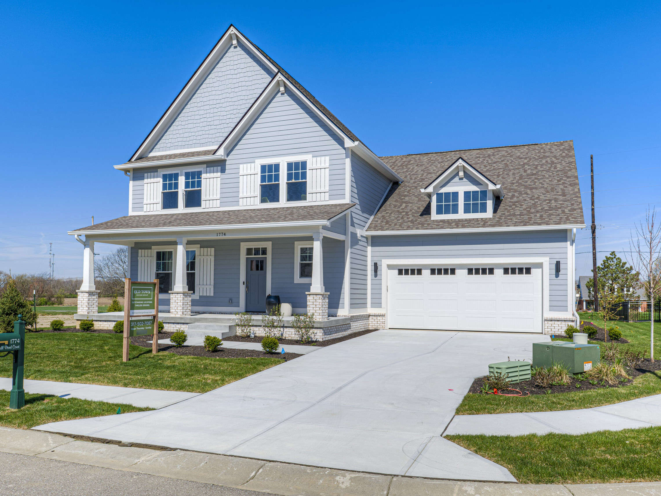 A home with two garages and a driveway, perfect for those in search of a custom-built residence in Fishers or Westfield, Indiana.