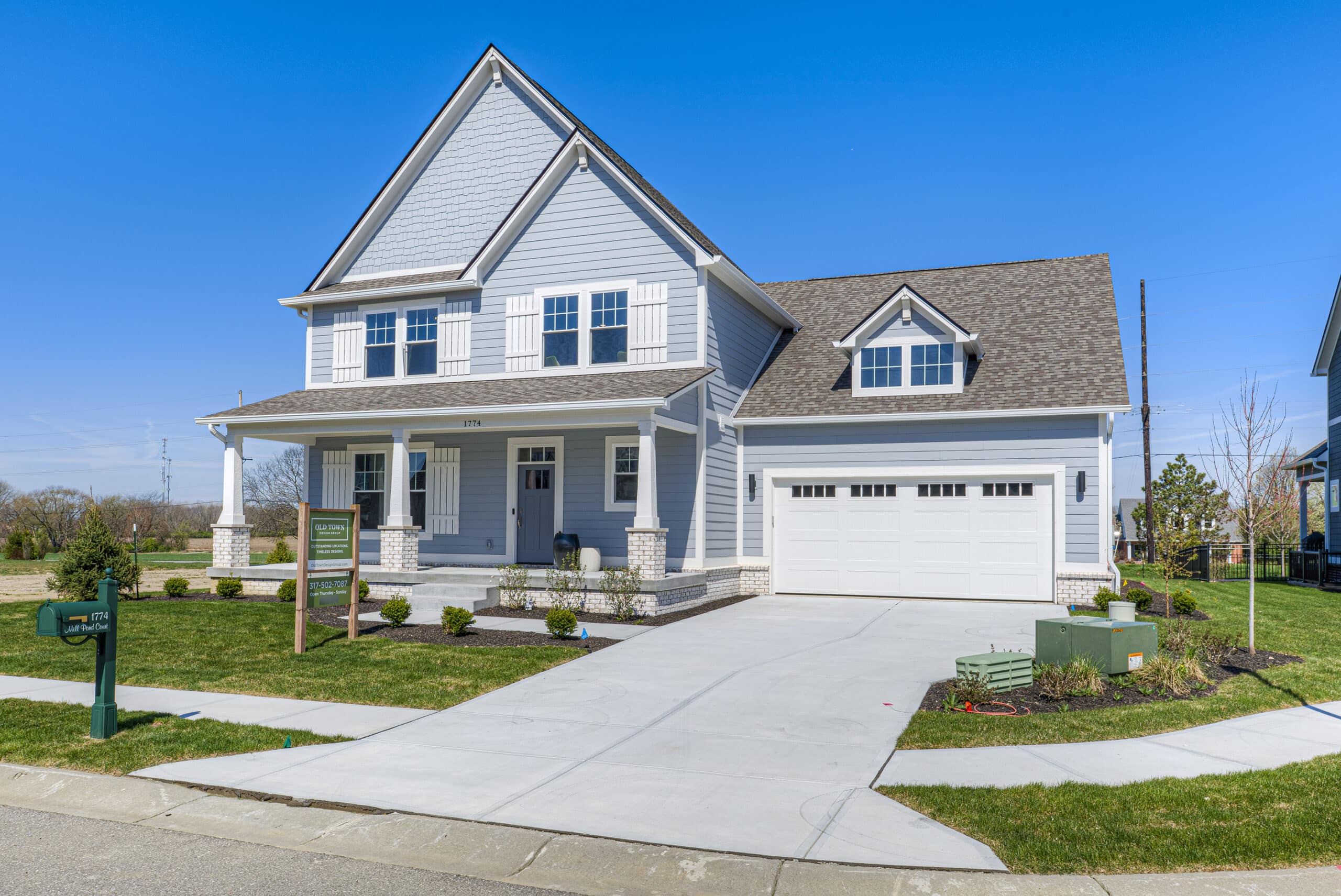 A home with two garages and a driveway, perfect for those in search of a custom-built residence in Fishers or Westfield, Indiana.