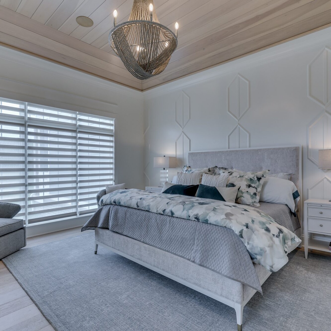 A bedroom with wood ceilings and a white bed.
