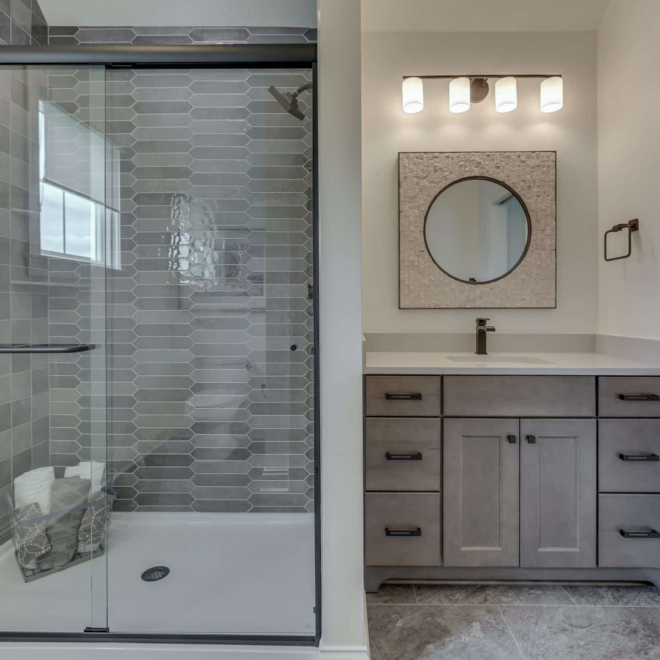 A gray bathroom with a glass shower stall.
