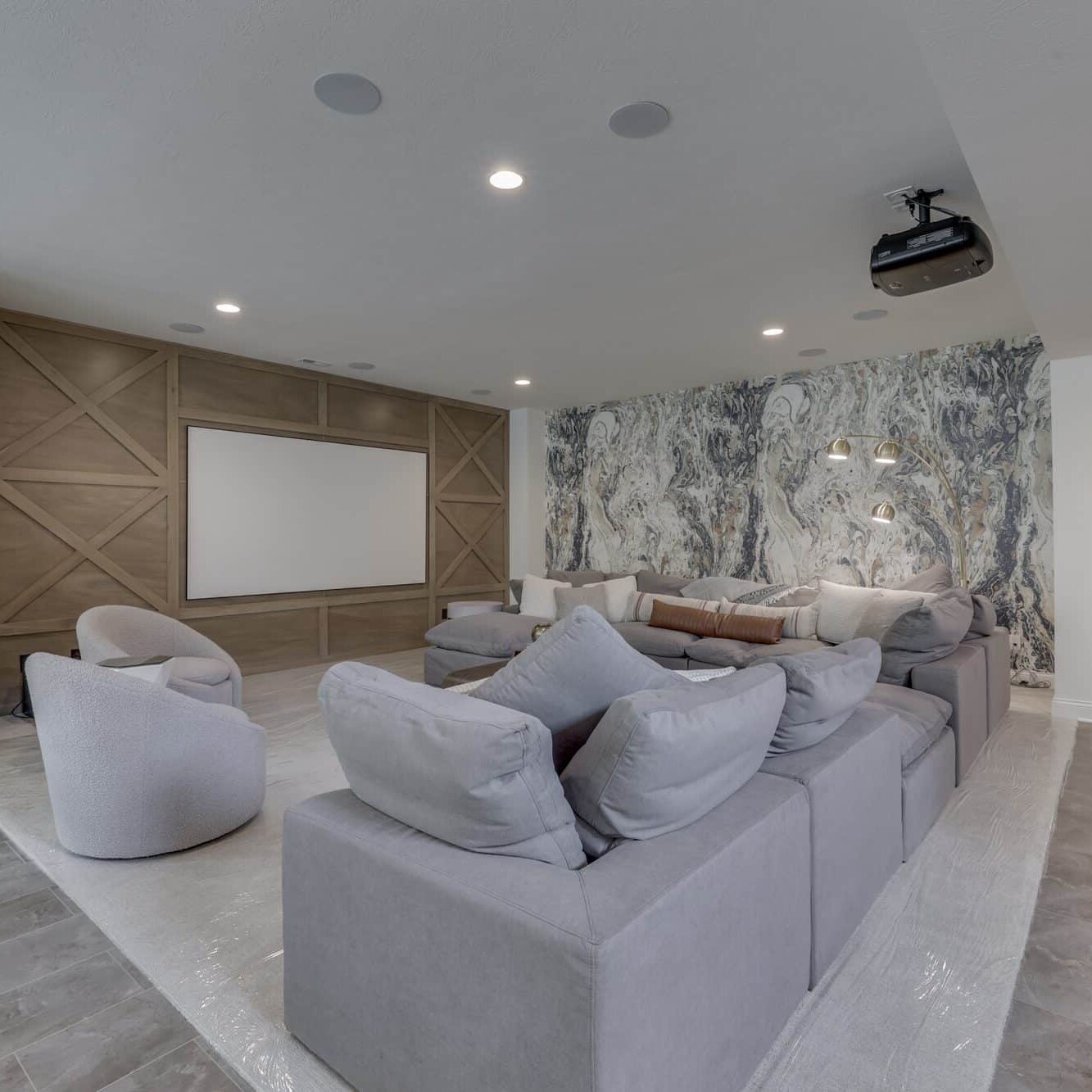 A home theater with a large screen and couches.