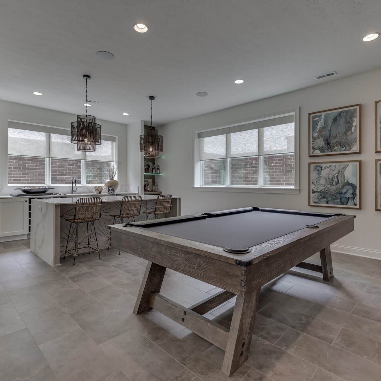 A game room with a pool table.