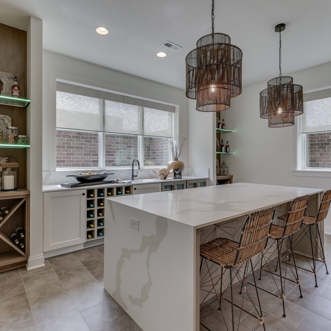 A kitchen with a large island and bar stools.