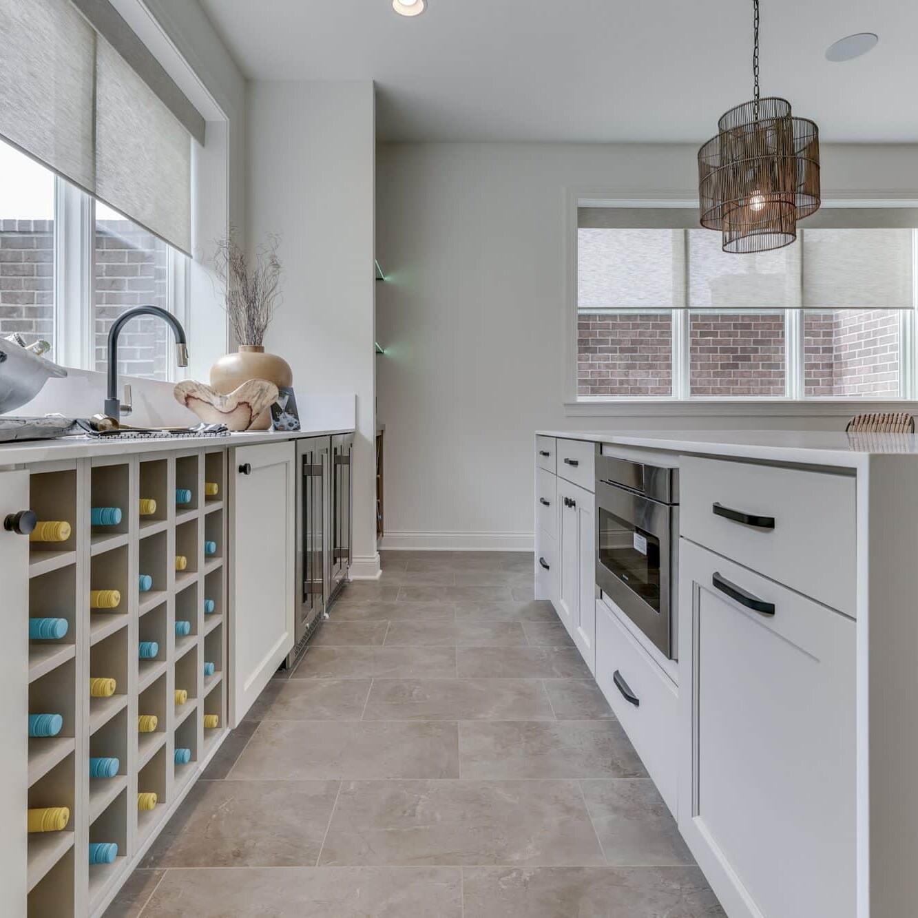 A kitchen with white cabinets and a wine rack.