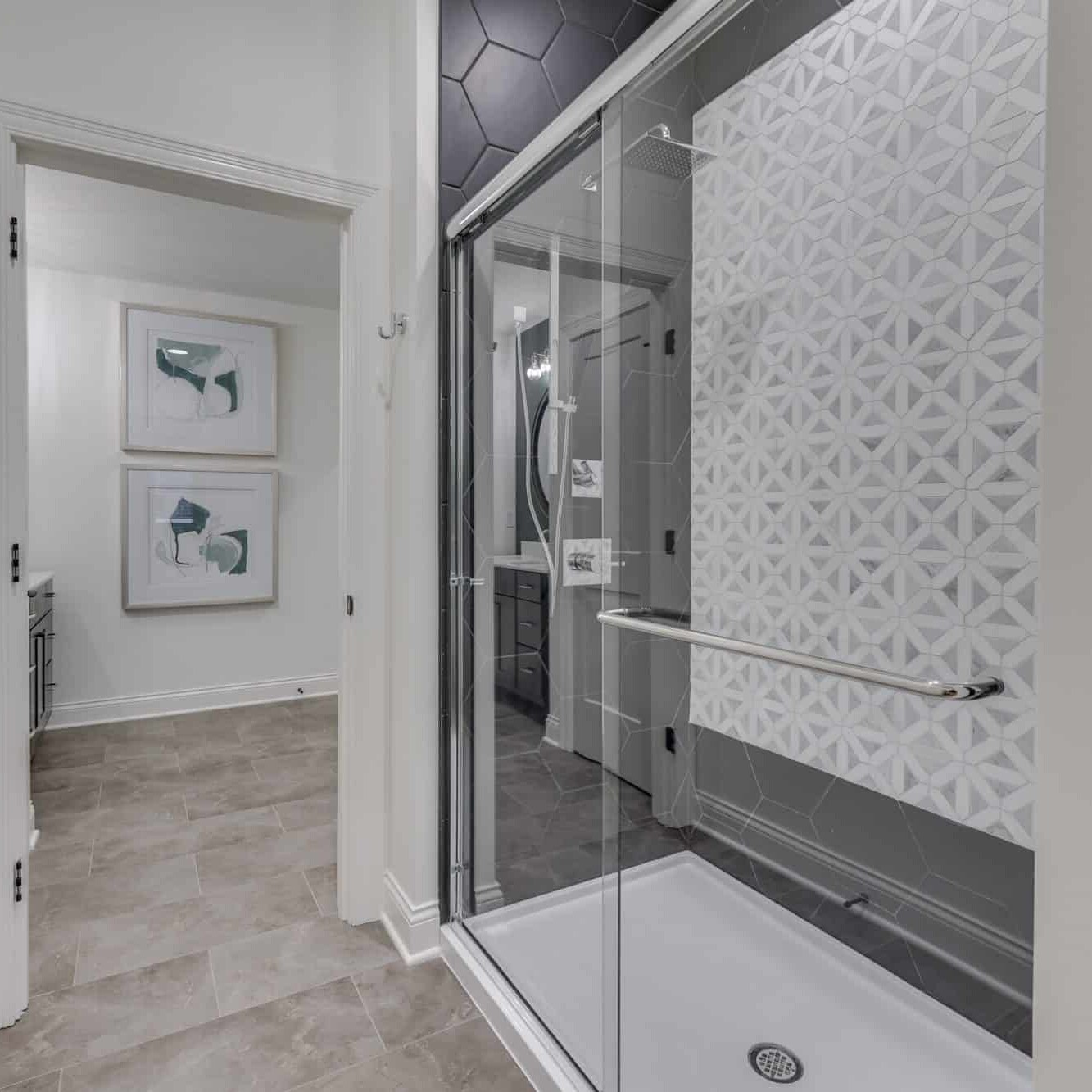 A bathroom with a glass shower door.