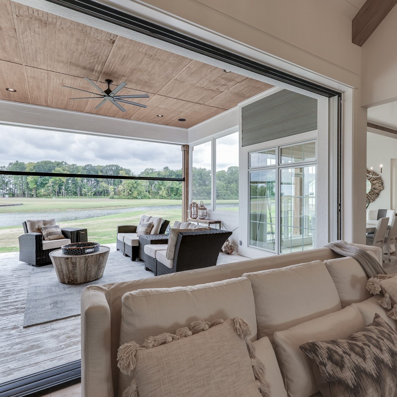 A living room with sliding glass doors and a view of a golf course.