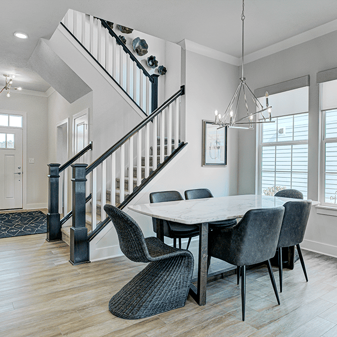 A dining room and stairway in a home.