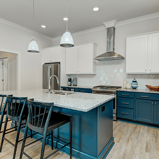 A kitchen with white cabinets and blue counter tops.