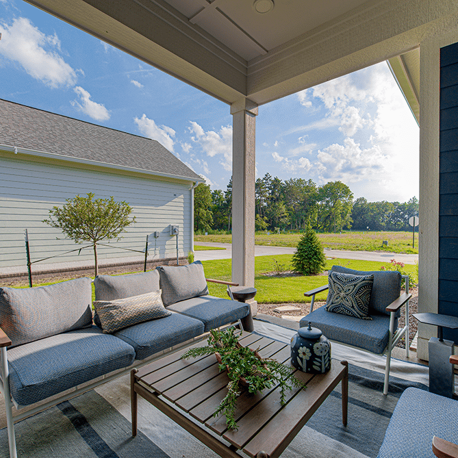 A blue couch on a porch.