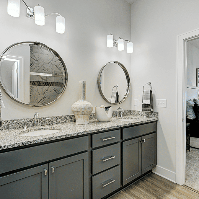 A bathroom with two sinks and two mirrors.