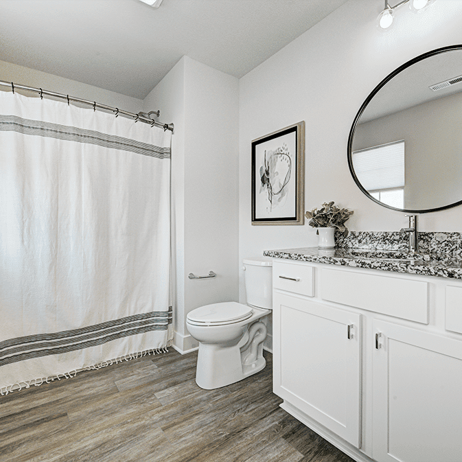 A white bathroom with a shower curtain.