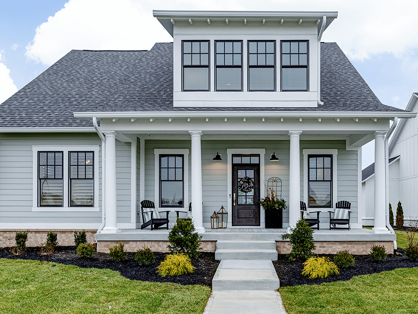 A home with a white front porch and white siding.