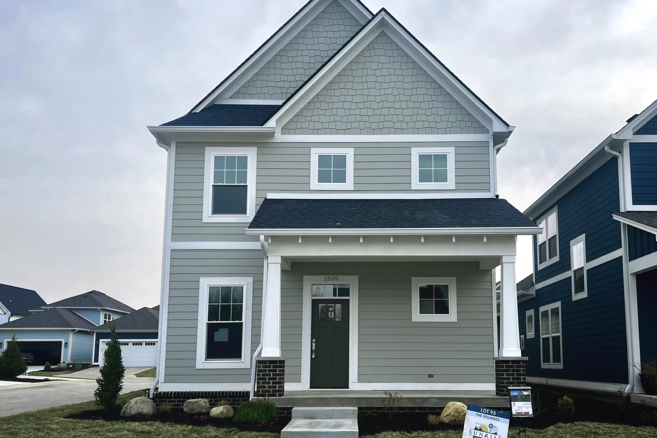 A two story Indianapolis custom home with gray siding and white trim.