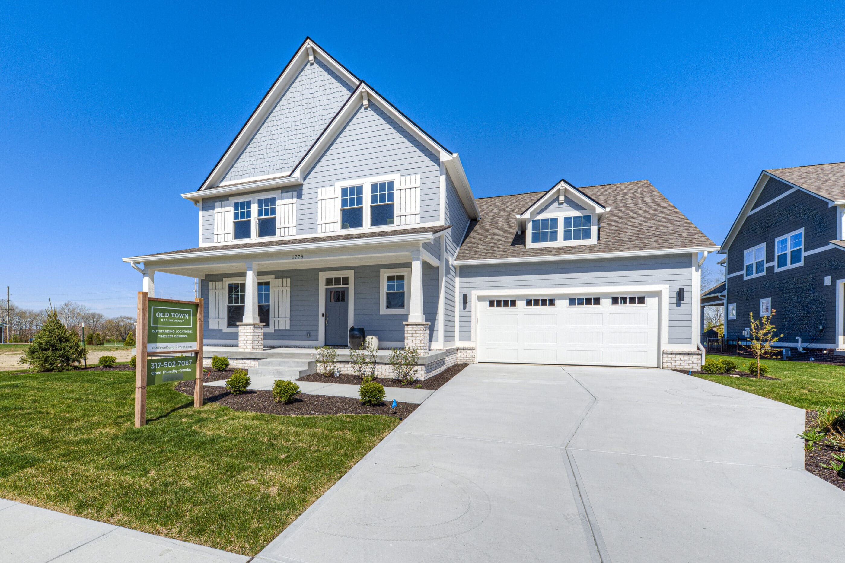 Keywords: Luxury custom home builder Westfield Indiana. 

Description: A two story luxury custom home with a garage and driveway, built by a premier custom home builder in Westfield, Indiana.