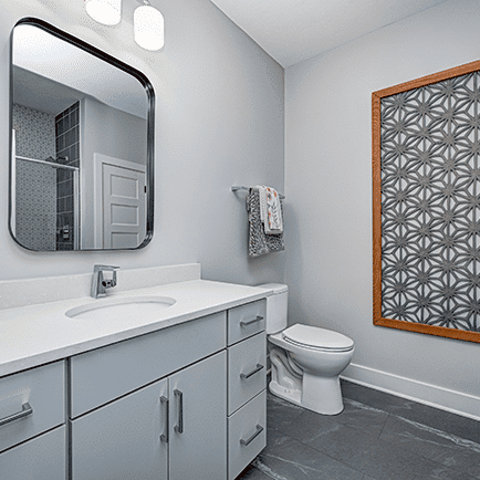 A gray tiled bathroom.