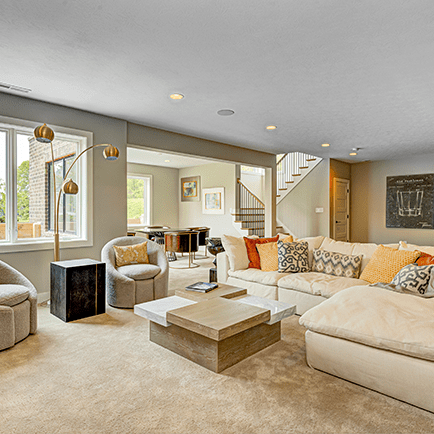 A living room with a couch, chairs, and a coffee table.