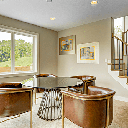 A room with a table and chairs.