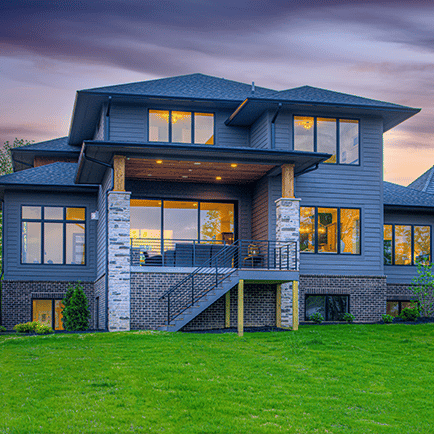 A large house on a green lawn.