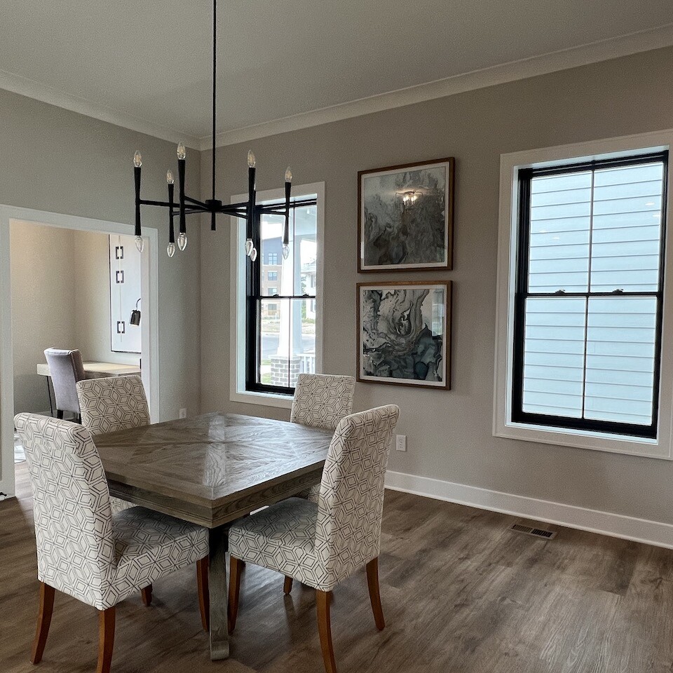 A spacious dining room furnished with a table and chairs, ideal for families residing in new custom homes or Indianapolis custom homes.