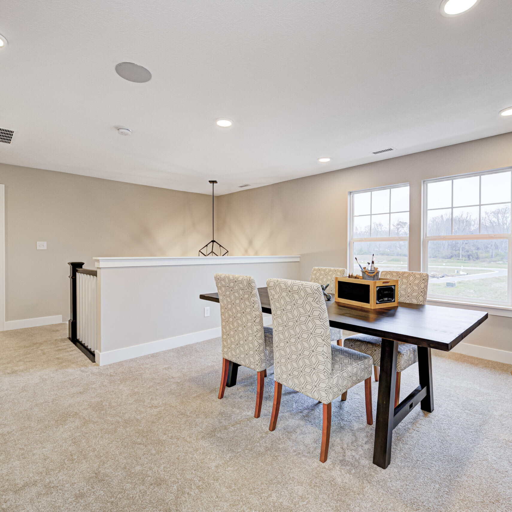 A dining room with a table and chairs created by a Custom Home Builder Fishers Indiana.