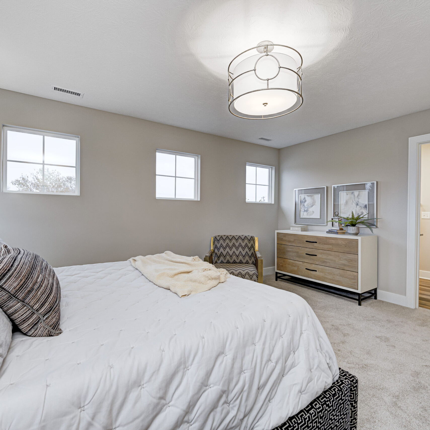 A bedroom with a bed and a dresser, perfect for new homes.