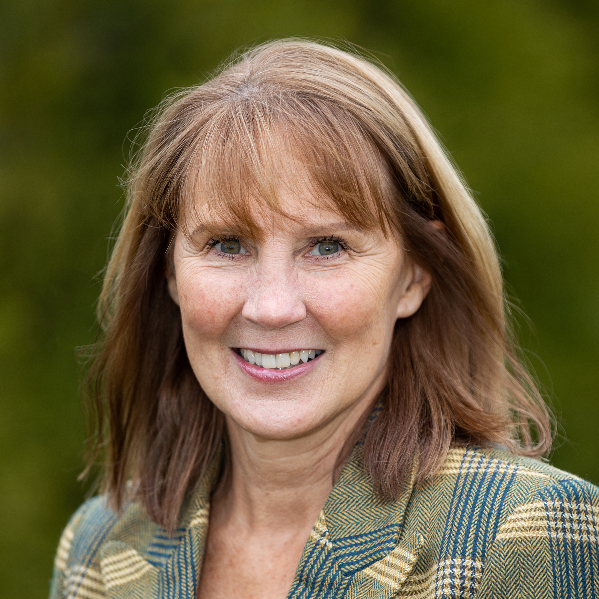 A woman wearing a plaid jacket in her newly built custom home in Westfield, Indiana.