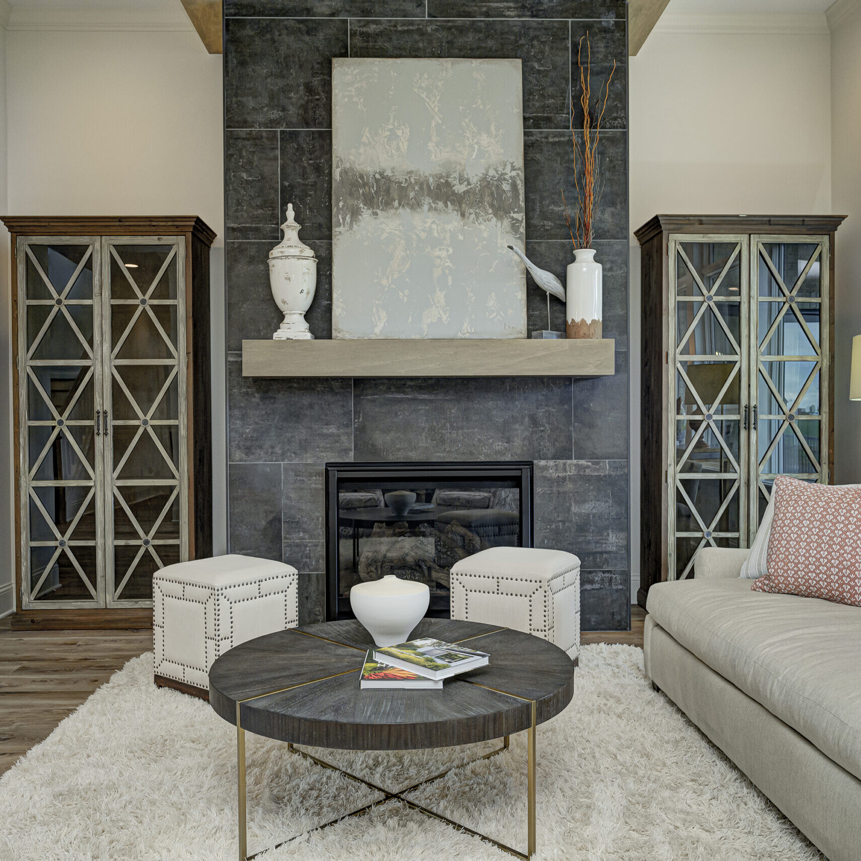 A cozy living room with a fireplace and a coffee table in a custom home.