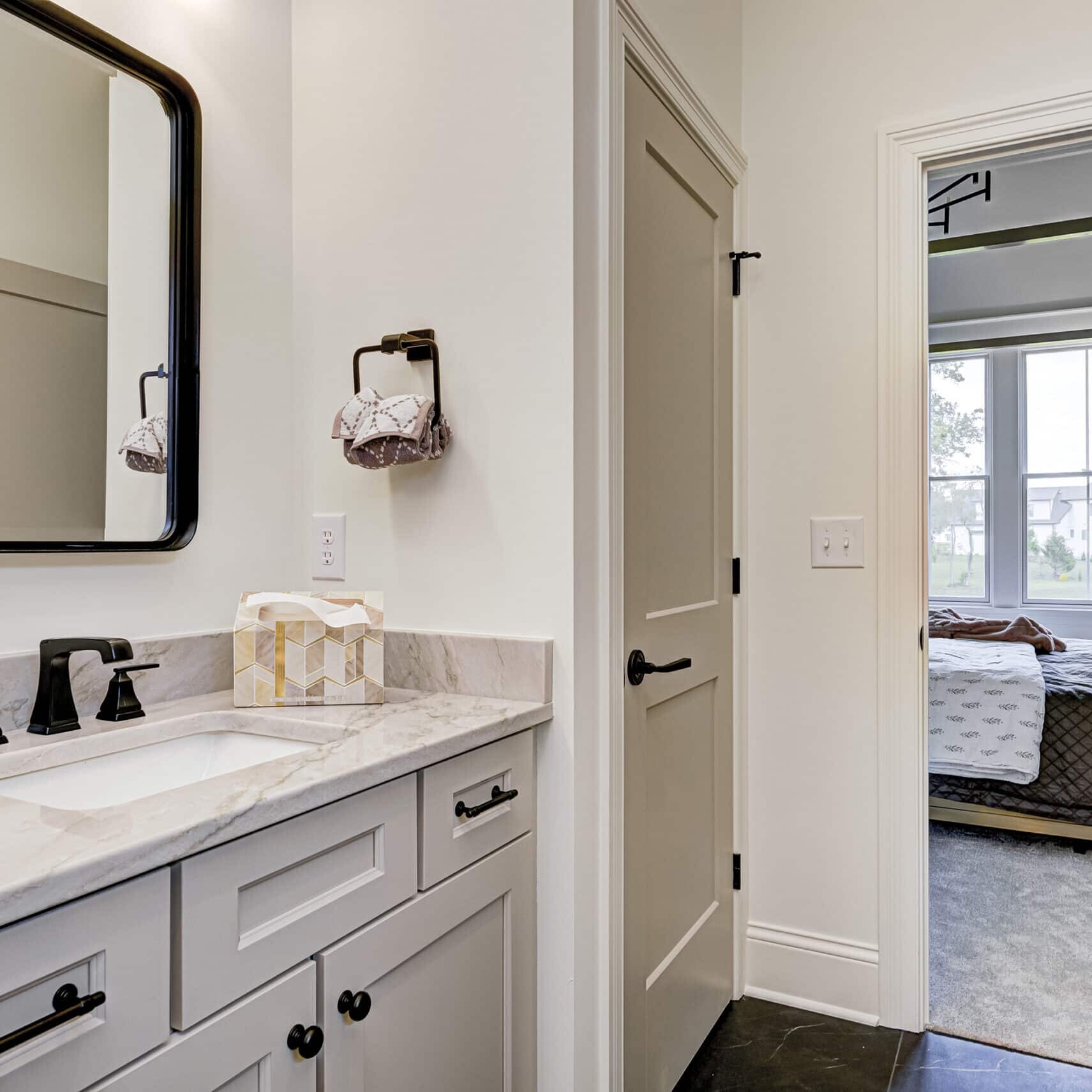 A custom bathroom with two sinks and a mirror in a new home built by a Custom Home Builder in Carmel, Indiana.