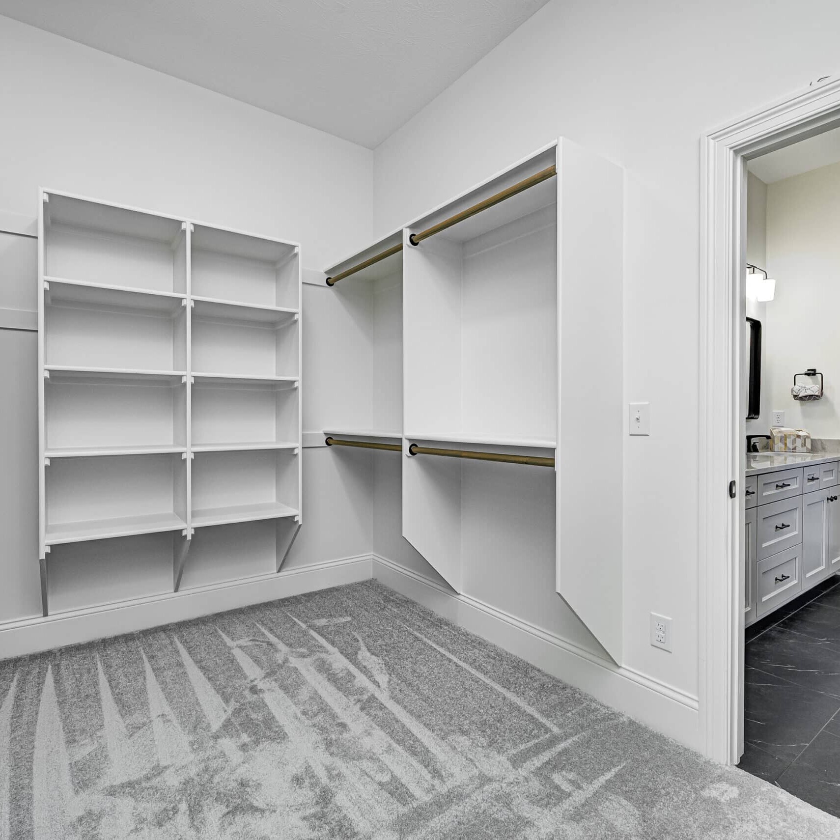 A walk-in closet with shelves and drawers in a custom-built home by a trusted custom home builder in the Indianapolis area.