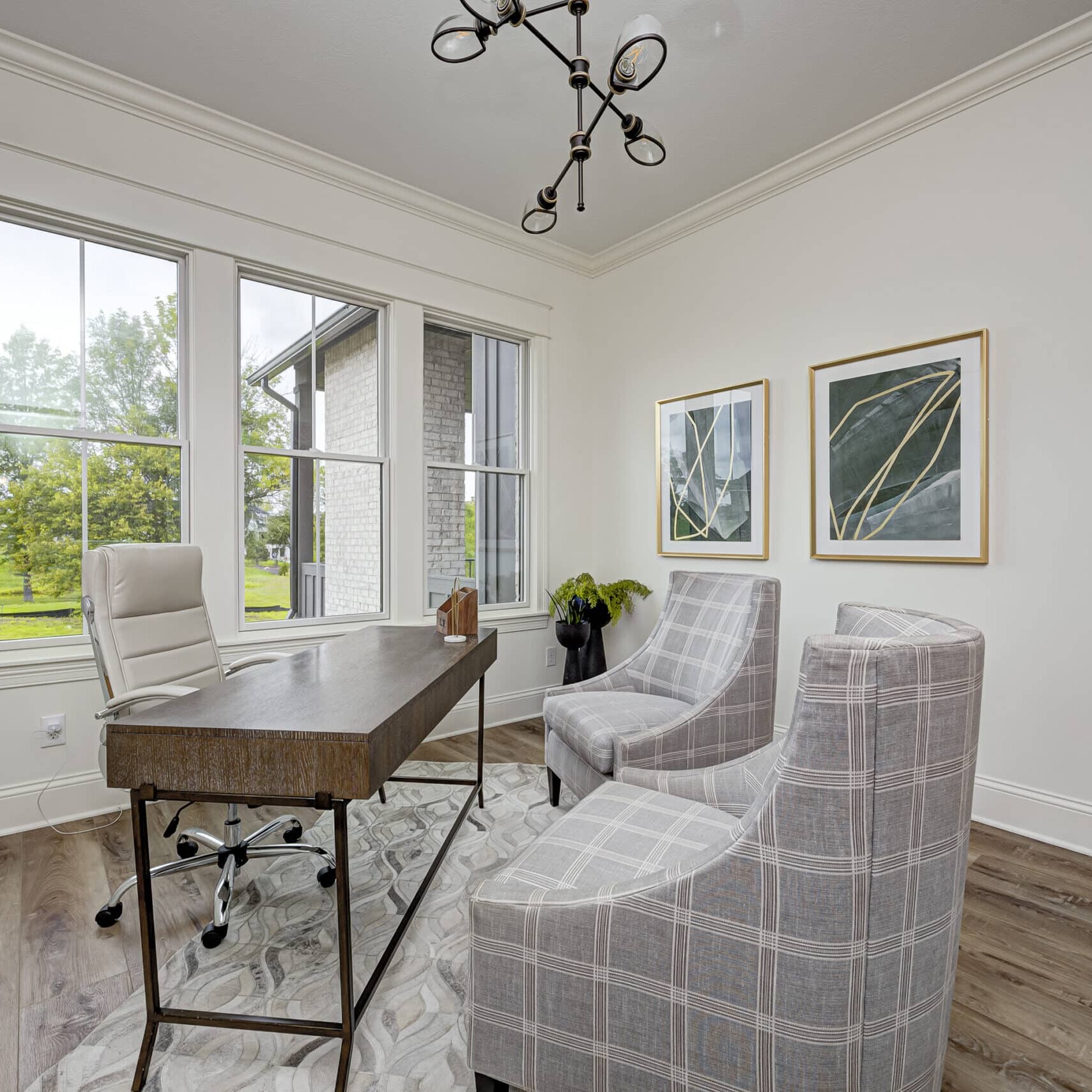 A custom home office in Carmel Indiana with two chairs and a window.