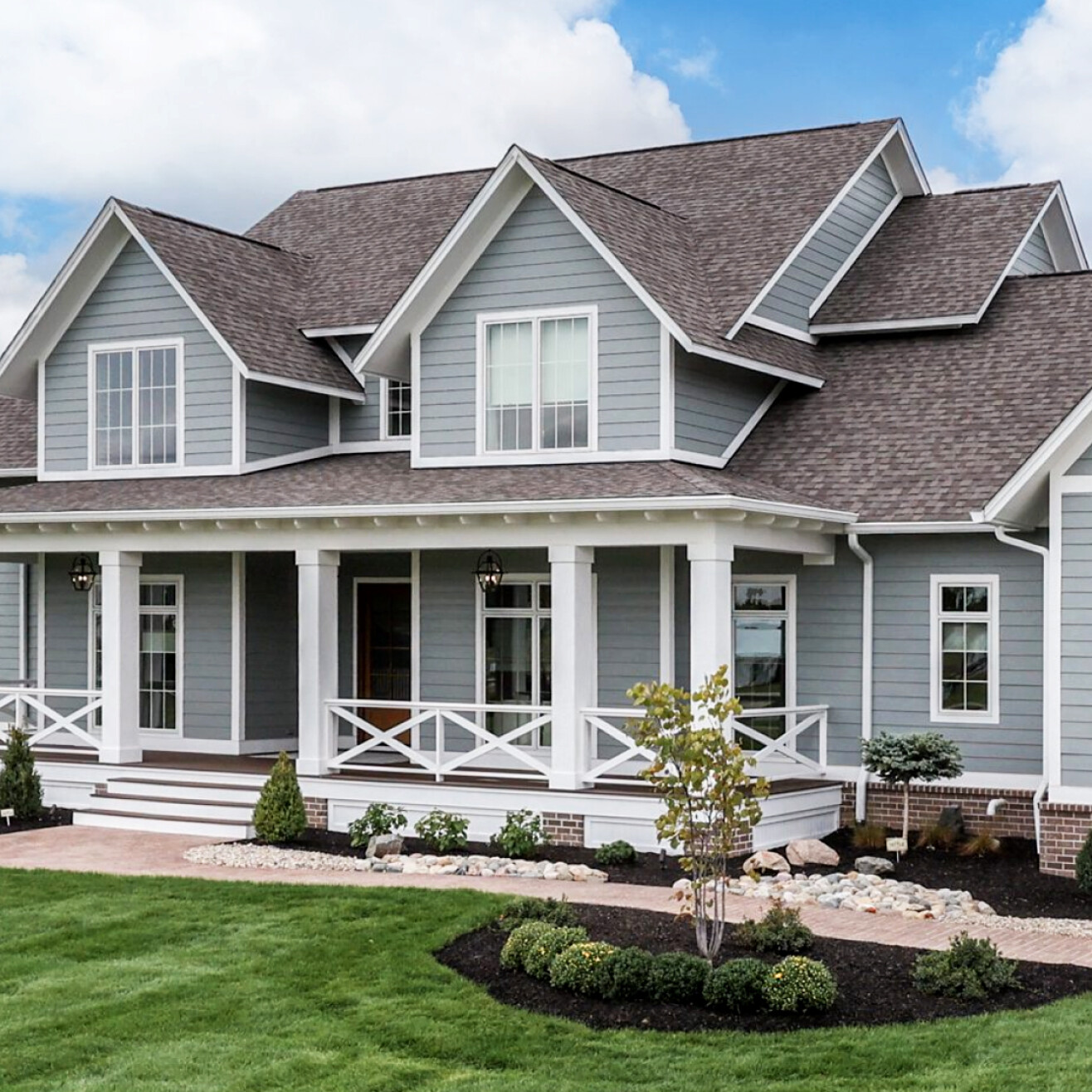 A custom home with gray siding and white trim, built by a reputable custom home builder in Carmel, Indiana.