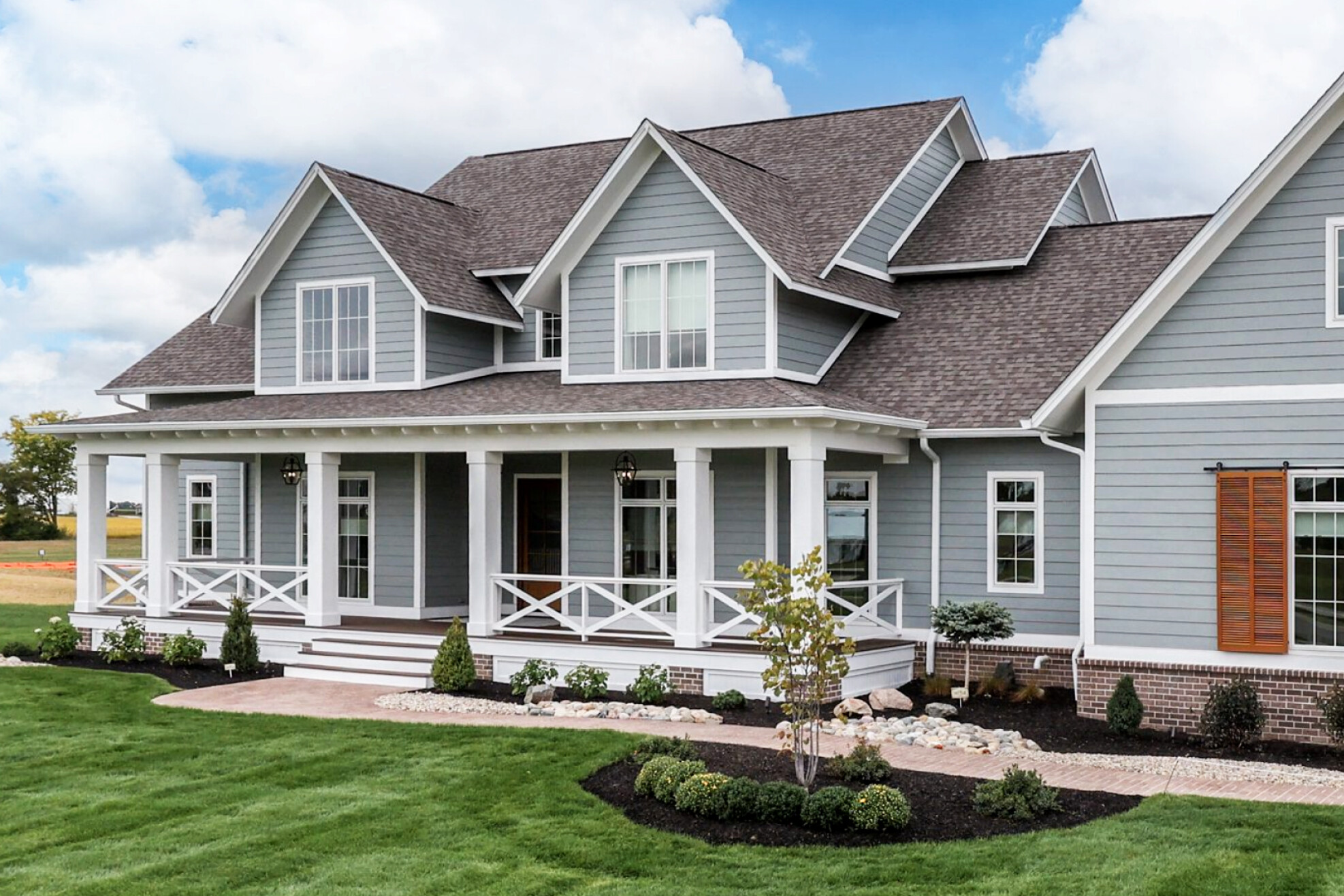 A custom home with gray siding and white trim, built by a reputable custom home builder in Carmel, Indiana.