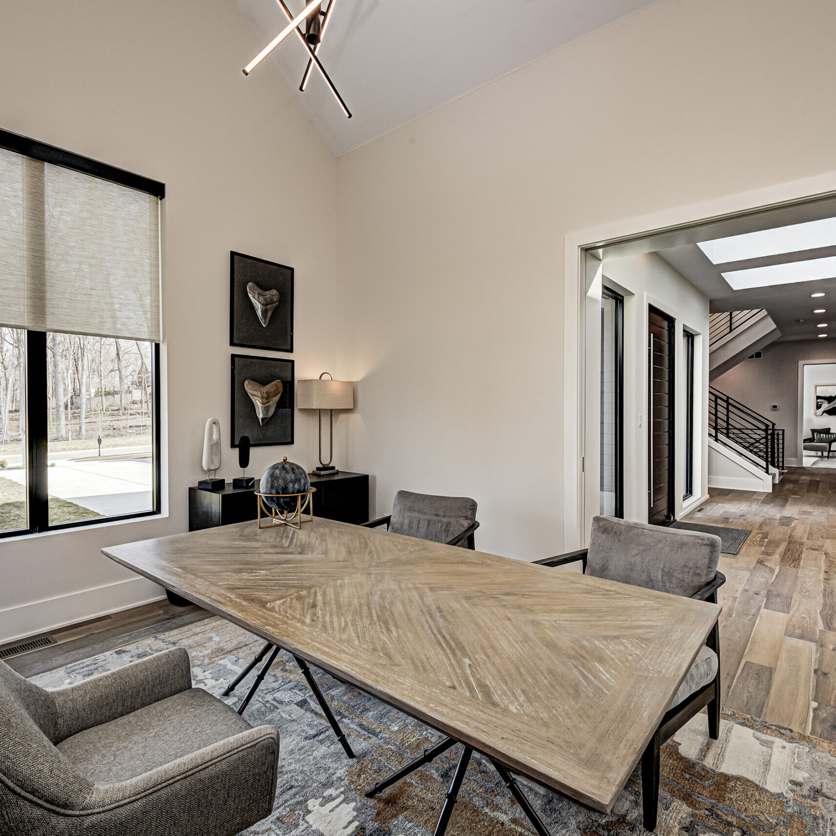 A dining room with a wooden table and chairs.