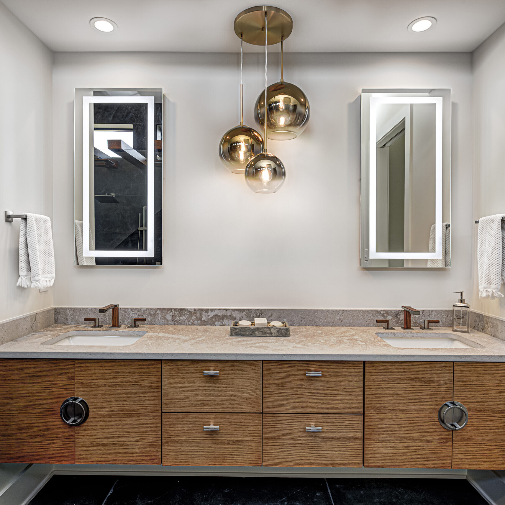 A modern bathroom with two sinks and a mirror.