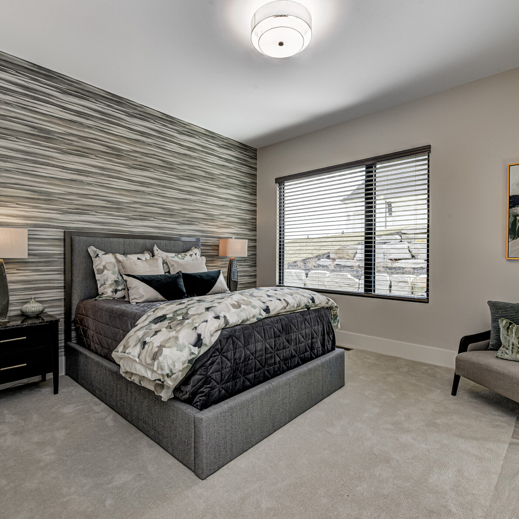 A bedroom with gray walls and a bed.