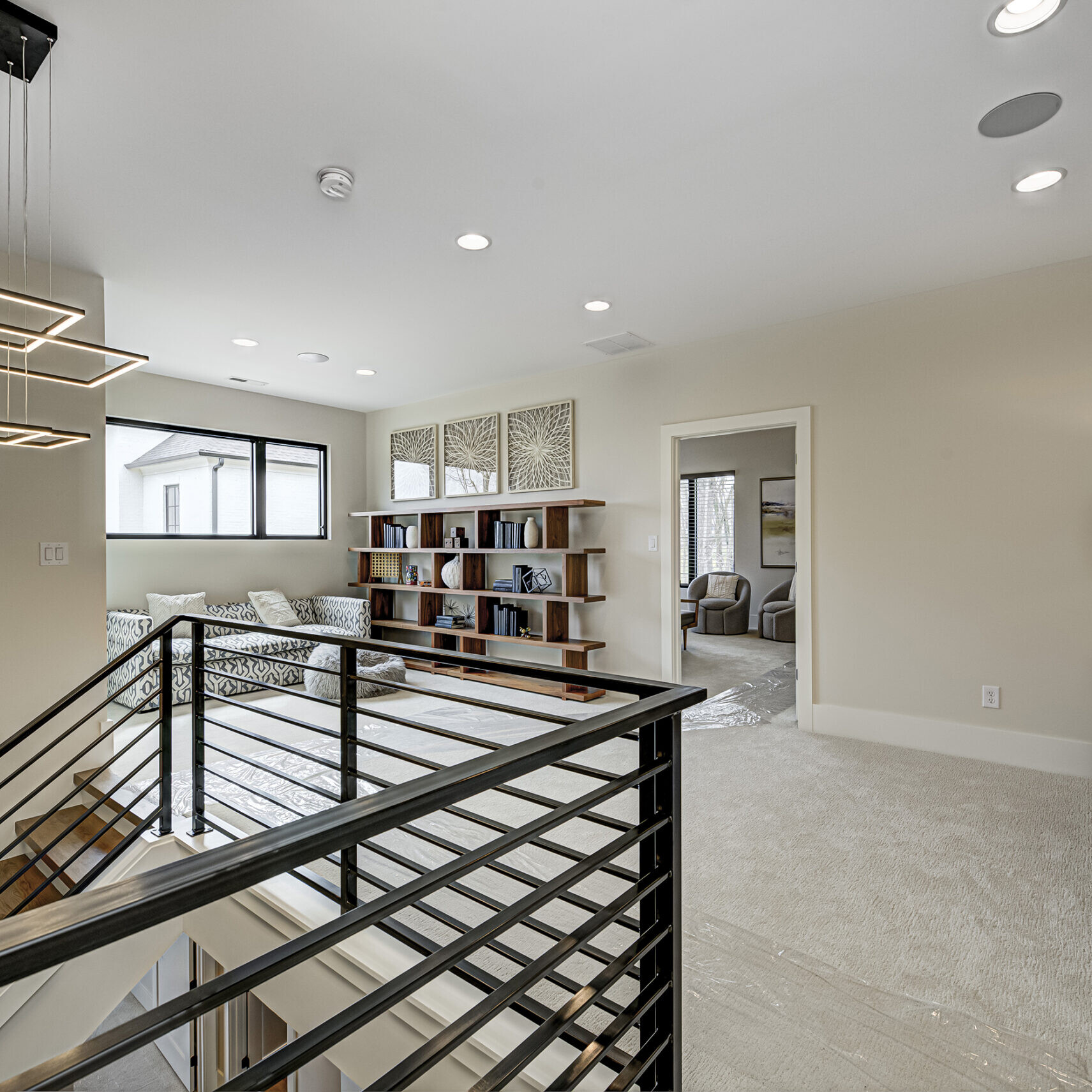 A modern home with a staircase and bookshelf.