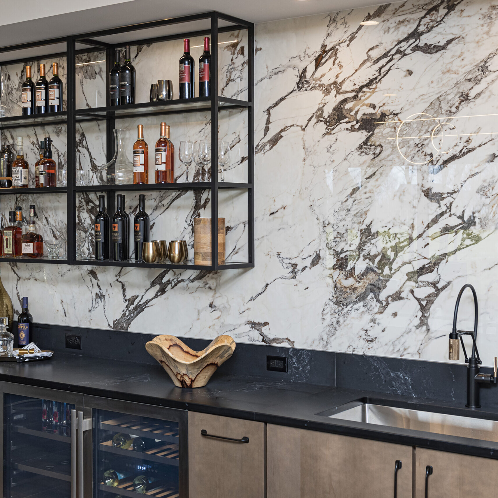 A kitchen with marble counter tops and a wine rack.