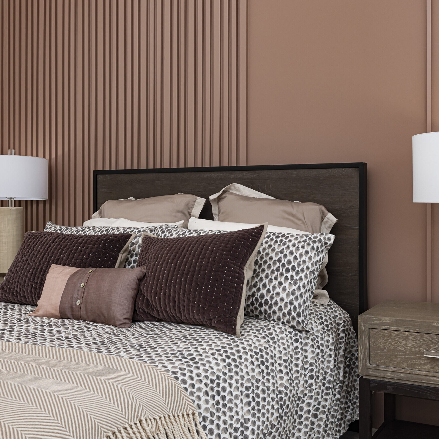 A bedroom with brown walls and a bed.